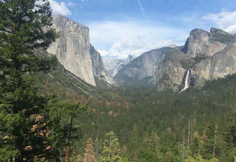 View of Yosemite mountains and waterfall in distance