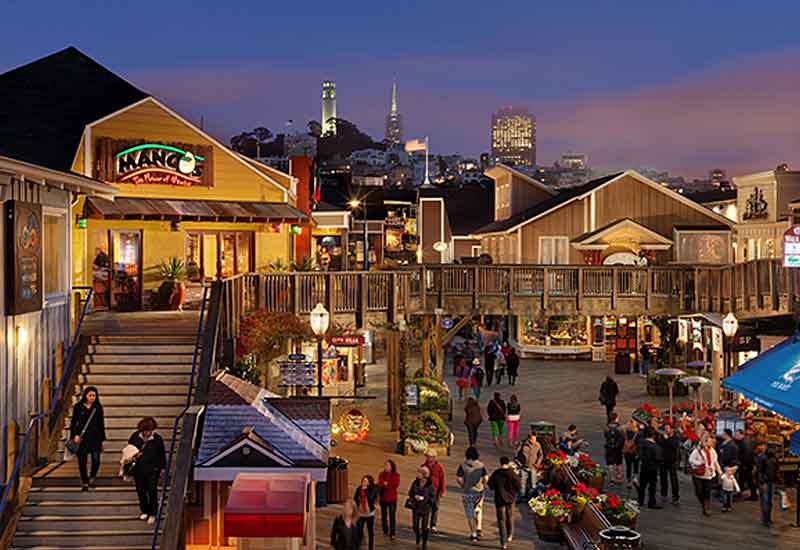 Shops and boardwalk at sunset at San Francisco Pier 39