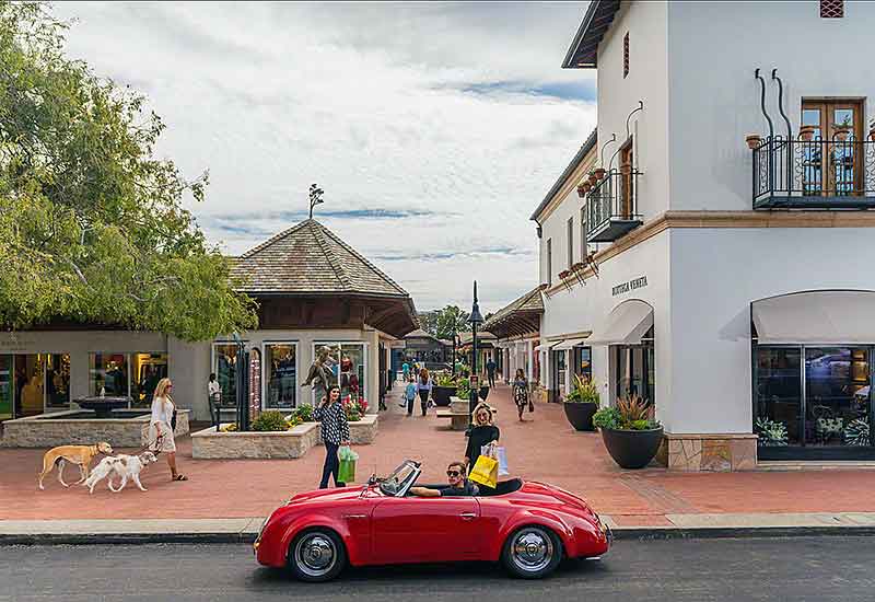 Red sports car in front of shops at Carmel By The Sea