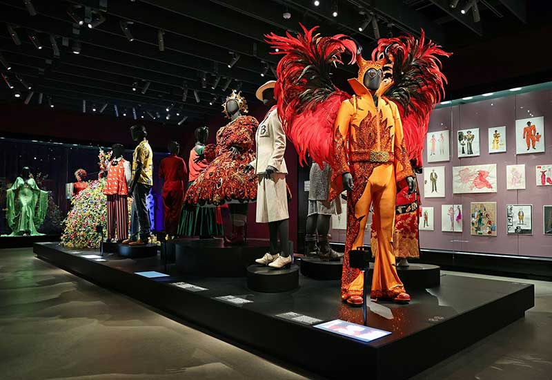 A vibrant showcase of costumes and mannequins, showcasing a variety of colors and styles.